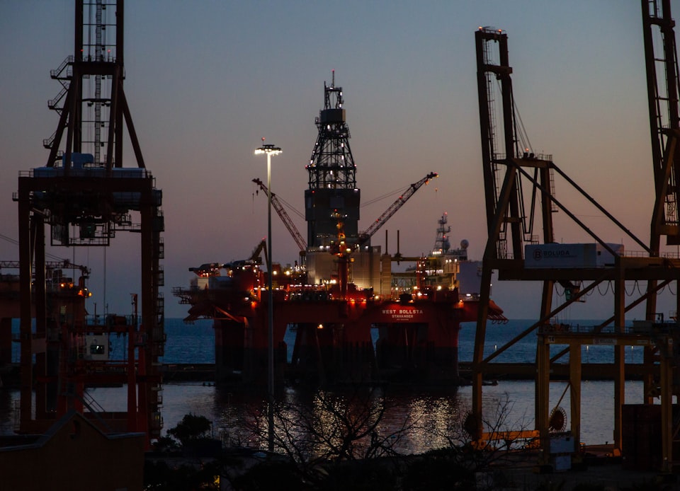 Drilling tower silhouette at golden sunset